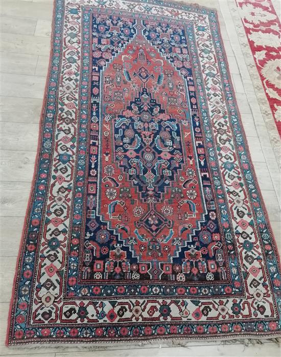 A Caucasian brick red ground rug 255 x 130cm